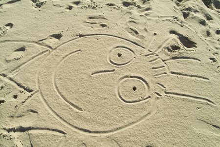 drawing in the sand : funny faceの写真素材