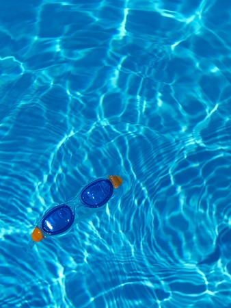 goggles floating in a swimming pool, holiday conceptの写真素材