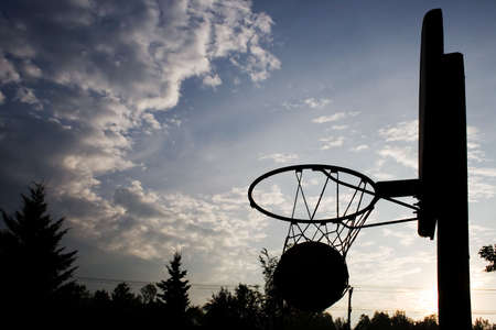 Silhouette of a basketball netの写真素材