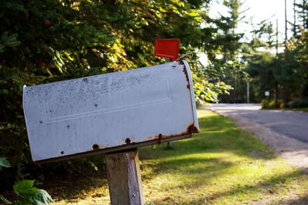 Old mailbox on a rural road with the flag upの写真素材