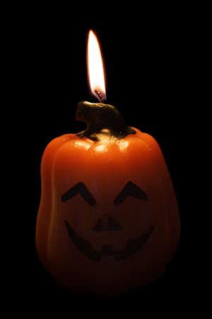 Pumpkin candle with flame isolated on white backgroundの写真素材