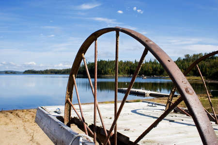 Old rusty wheel on a beautiful landscapeの写真素材