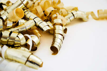 Gold and white curly ribbon isolated on white backgroundの写真素材