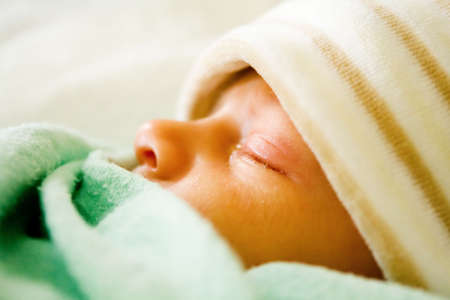 Baby sleeping with tuqueの写真素材