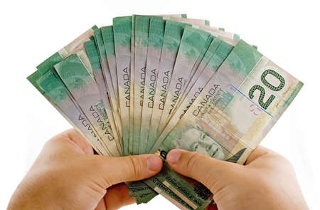 Hands with canadian dollars isolated on a white backgroundの写真素材