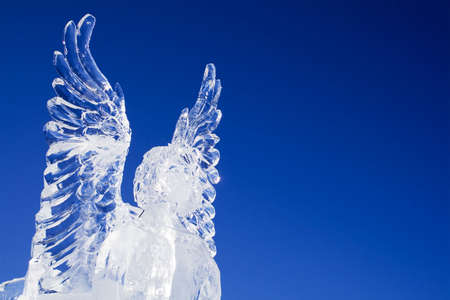 Ice angel looking ahead on a beautiful blue skyの写真素材
