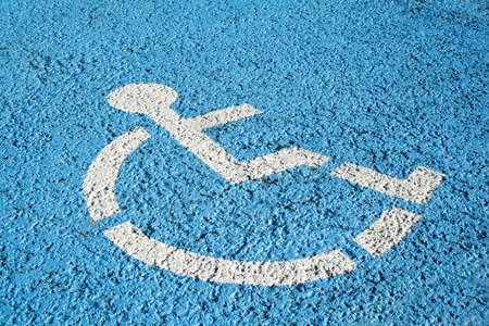 Blue handicap parking or wheelchair accessible sign in parkingの写真素材