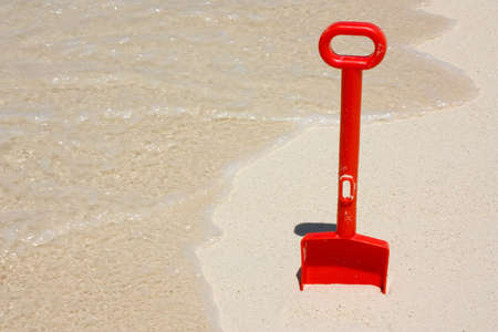 Toy shovel at the beachの写真素材