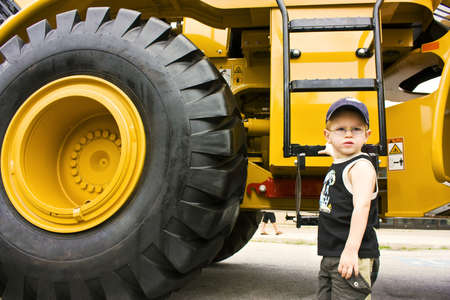 Little boy ready to work on a construction truck