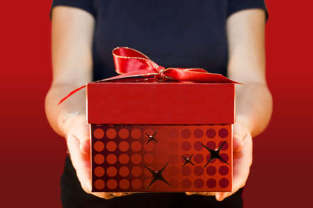 Man holding and offering a gift to someone