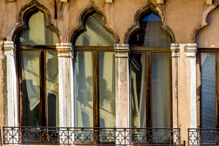 Building exterior with traditional ancient gothic style windows in Venice, Italy