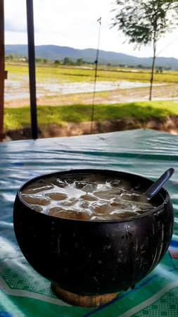 Coconut milk in black pot on the tableの写真素材