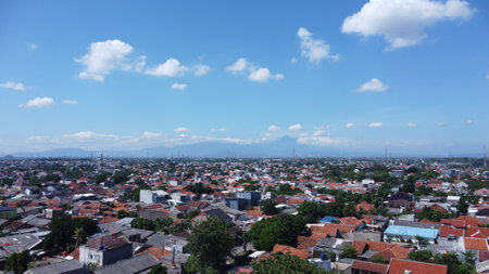 panoramic view of city with blue sky and white clouds.の写真素材