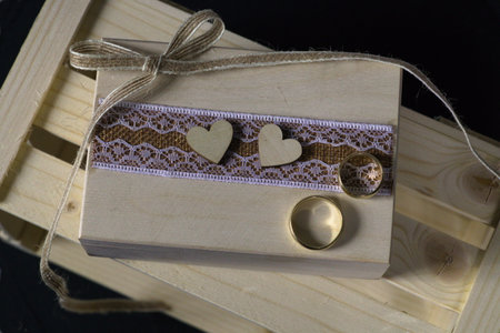 Rustical wedding box and golden ringsの写真素材
