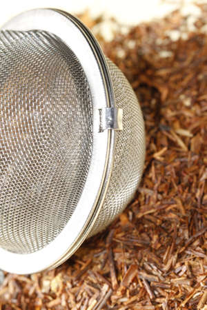 rooibos tea close up with tea strainerの写真素材