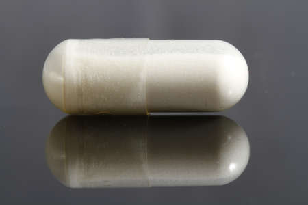close up of white gelatin capsule on black backgroundの写真素材