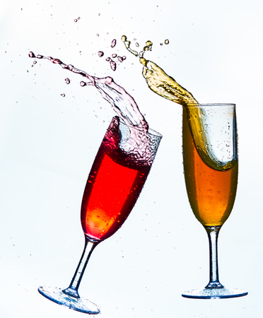 Colorful splash in champagne glass isolated on white backgroundの写真素材