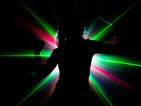 silhouette of woman dancing on abstract backgroundの写真素材