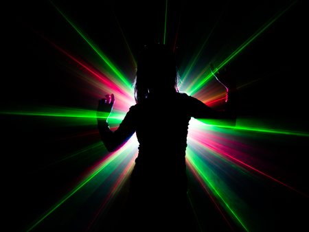 silhouette of woman dancing on abstract backgroundの写真素材