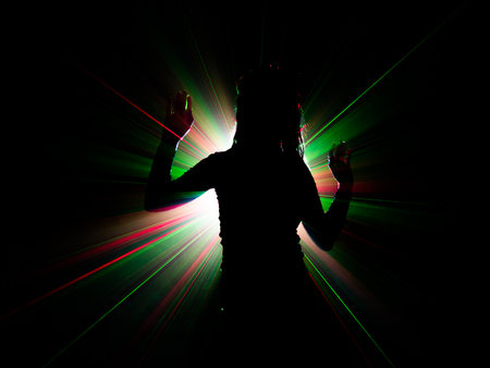 silhouette of woman dancing on abstract backgroundの写真素材