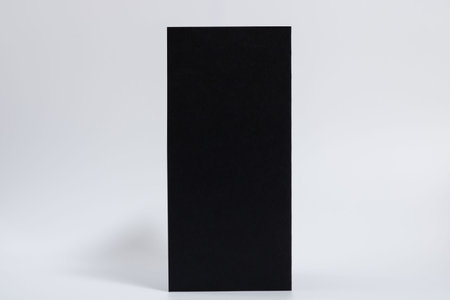 mockup of a black vertical brochure on a white horizontal backgroundの写真素材