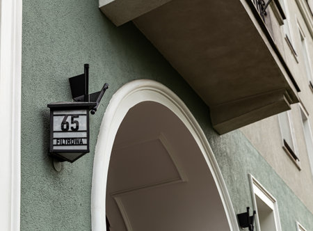 an old plaque with an address on a tenement house