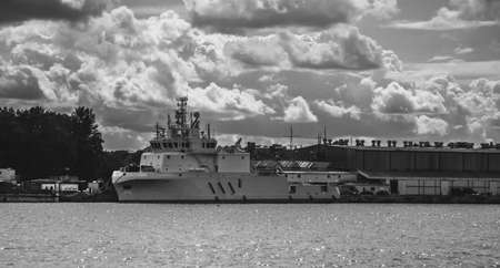Ships in a seaport against the background of shipyard cranesの写真素材