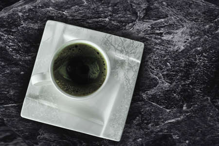 A cup of coffee on a black backgroundの写真素材