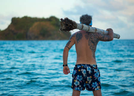 A man standing by the sea. Tatoosのeditorial素材