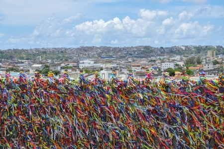 Brazil, Salvador de Bahia, Church of Senhor do Bonfim, fence with colored stripes in foregroundの写真素材