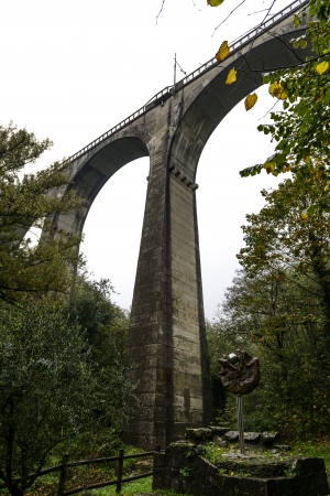 Arches of the railway bridge and war memorial in autumn, Piteccio  Tuscany, Italy の写真素材