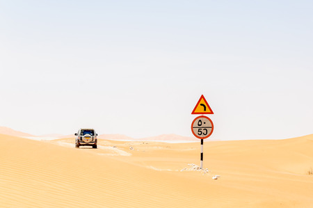 Road sign among sand dunes in Rub al-Khali desert, Dhofar region  Oman 