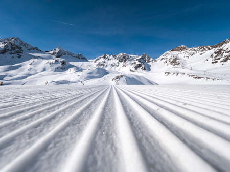 Ski tracks in the snow on a sunny day in the Alpsの写真素材
