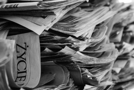 Stack of newspapers in black and white backgroundの写真素材