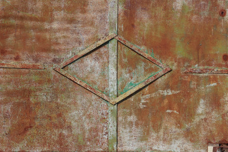 Texture of a rusty scratched metal surface with peeling and peeling old paintの写真素材