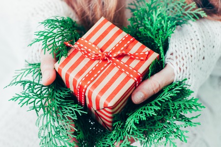 Christmas or new year gift box in womans hands.