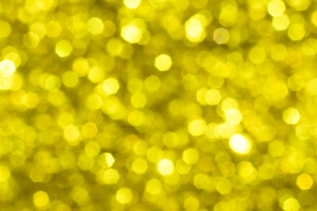 Golden glitter festive background with bokeh lights. Celebration concept for New Year, Christmas Holidays and happy valentine's day.の写真素材