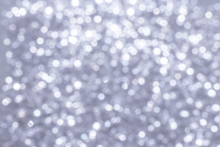 Silver glitter festive background with bokeh lights. Celebration concept for New Year, Christmas Holidays and anniversary.の写真素材