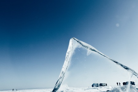 Blocks of ice gleaming in the sun. Arctic winter background. Winter ice along the shore.