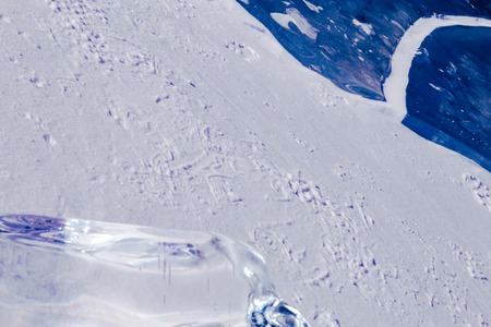 Blue ice texture. Abstract arctic winter background. Winter ice along the shore.の写真素材