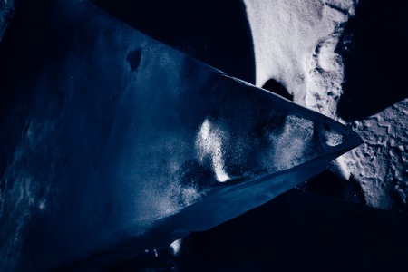 Blocks of ice gleaming in the sun. Arctic winter background. Winter ice along the shore.の写真素材