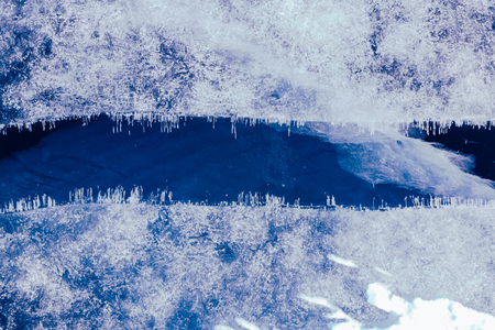 Blue ice texture. Abstract arctic winter background. Winter ice along the shore.の写真素材