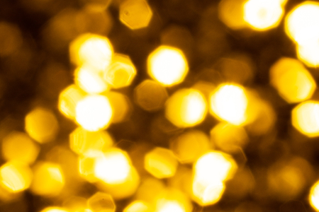 Golden glitter festive background with bokeh lights. Celebration concept for New Year, Christmas Holidays and happy valentine's day.の写真素材