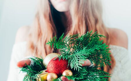 Gift box Christmas or New Year in the hands of a blonde woman.の写真素材