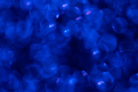 Golden glitter festive background with bokeh lights. Celebration concept for New Year, Christmas Holidays and anniversary.の写真素材