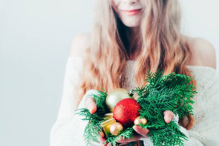 Gift box Christmas or New Year in the hands of a blonde woman.の写真素材