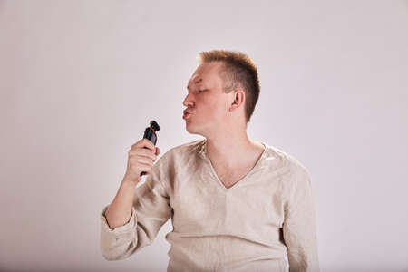 Man doing haircut by himself at home while Covid-19 quarantine. Self isolation lifestyle.の写真素材