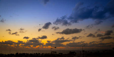 Beautiful evening sunset with clouds over the seaの写真素材