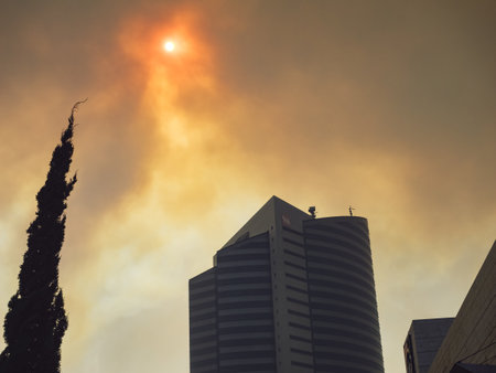 The sun through the smoke. Dirty air in the city.の写真素材