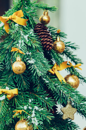 Green fir tree with golden balls. Christmas wallpaper.
